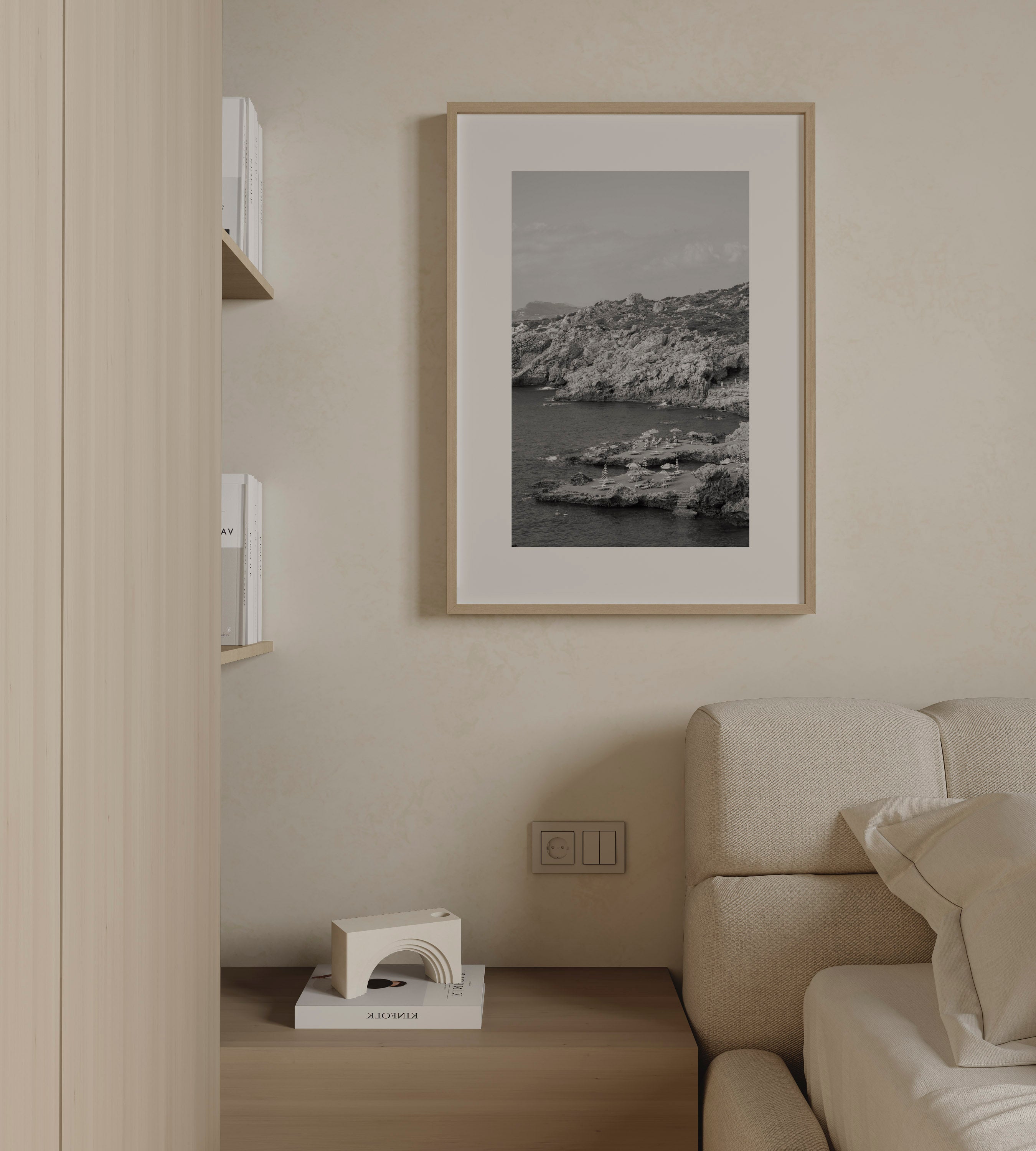 Shoreline Calm by Daniel Barlot – black and white fine art photograph of a tranquil Mediterranean rocky shoreline captured in Greece, framed in natural oak.