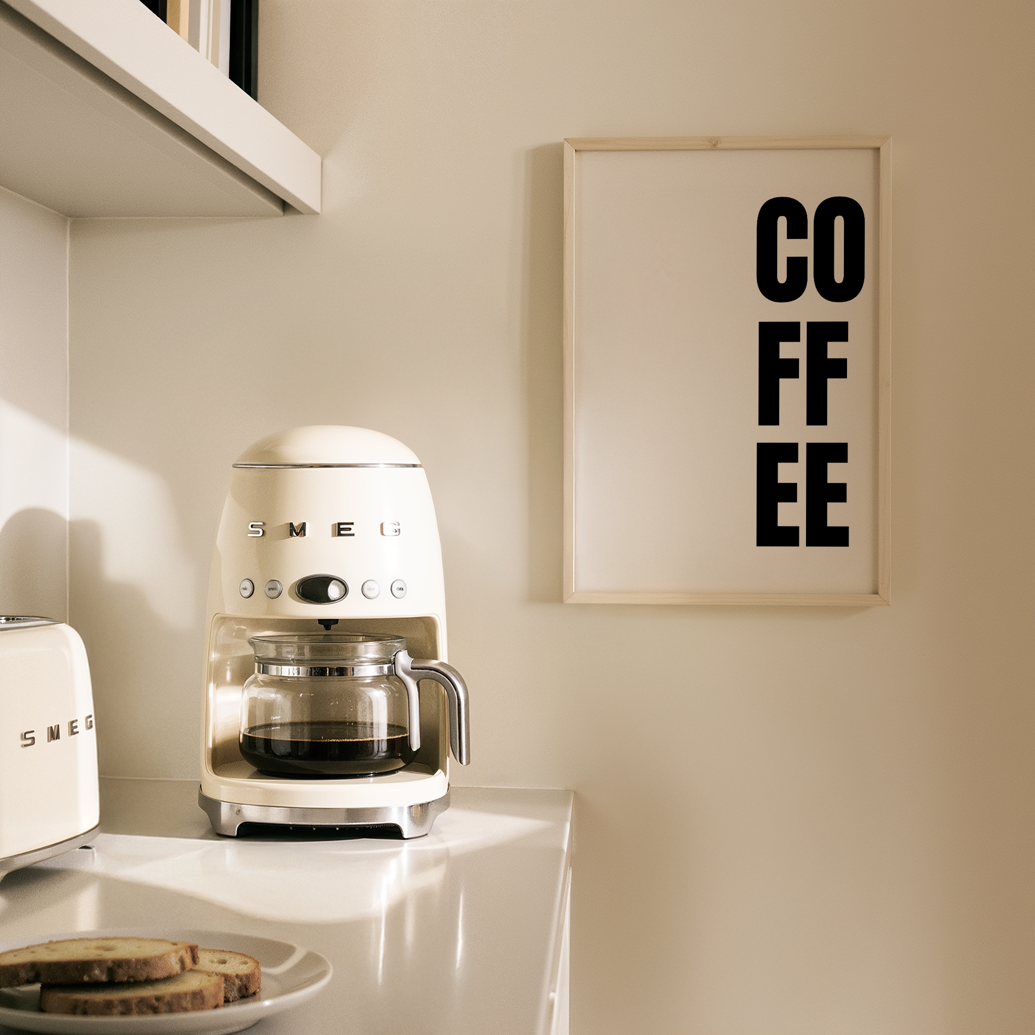 פוסטר טיפוגרפי עם כיתוב COFFEE באותיות שחורות על רקע בהיר, מתאים לפינת קפה במטבח.