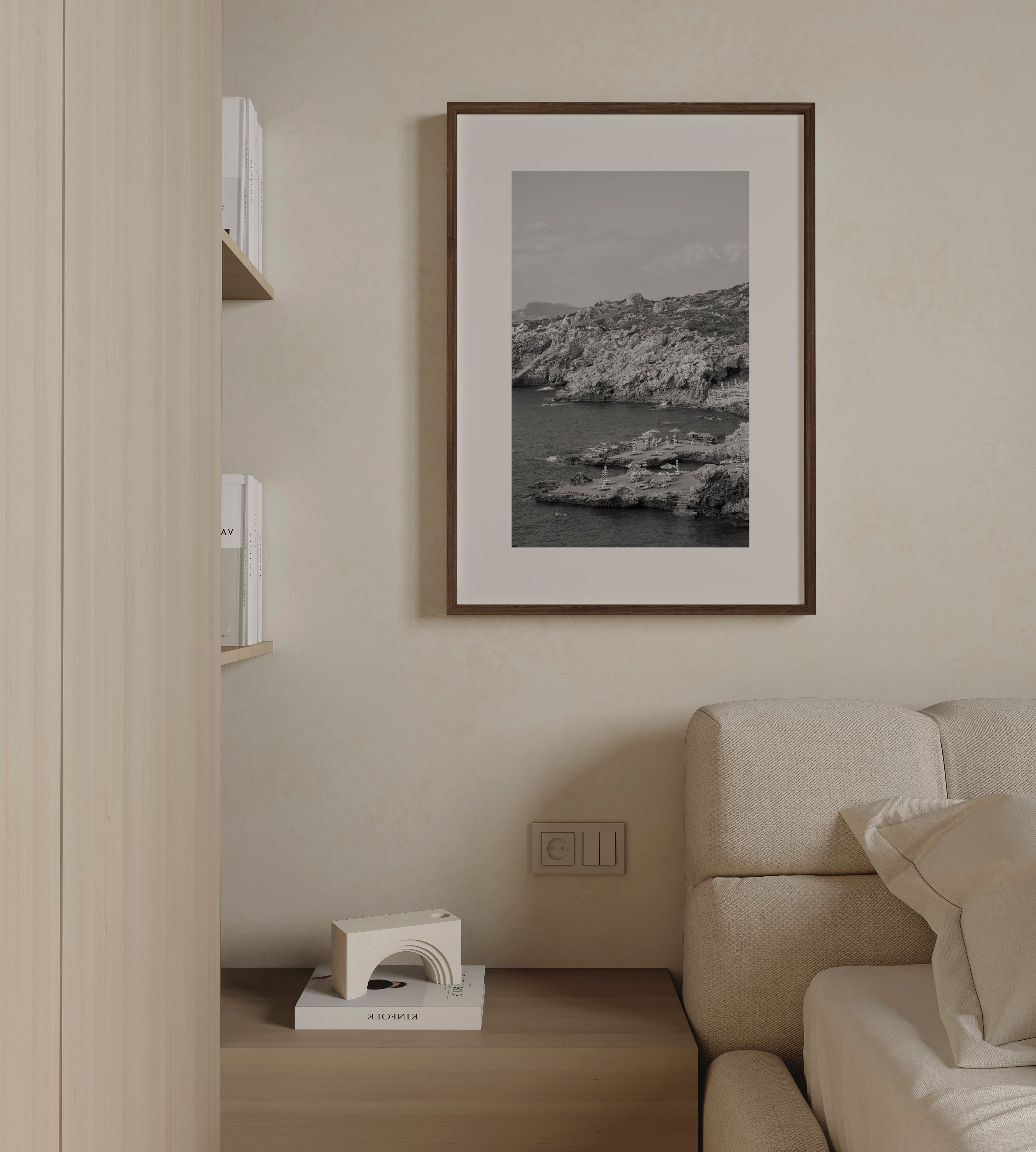 Shoreline Calm by Daniel Barlot – black and white fine art photograph of a tranquil Mediterranean rocky shoreline captured in Greece, framed in natural oak.